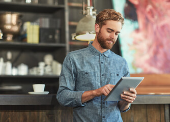 Owner, man and relax with tablet in cafe for social media update, menu planning and order management. Small business, person or digital for website reviews, inventory and stock schedule of restaurant