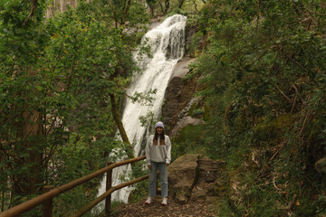 Traveler Poses in Front of Ribasieira Waterfall, Porto do Son