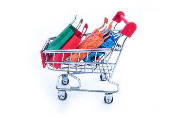 Trolley cart with colorful paper shopping bags isolated on white background. Creative idea for...