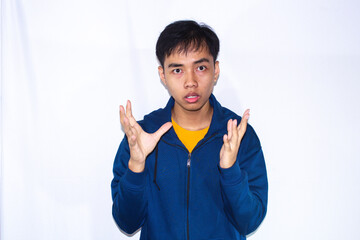a teenager wearing a dark blue jacket and yellow shirt, is explaining something worriedly