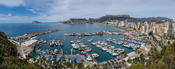 A beautiful view of a Calp - Alicante. Port with many boats docked. Panoramic image