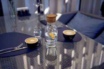 two cups of coffee, latte and cappuccino on a table in a cafe
