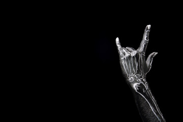 Rock'n'roll party theme. human hand painted as skeleton gesturing against black background. Costume party, festival, celebration. Concept of Halloween theme, holiday. Copy space for ad
