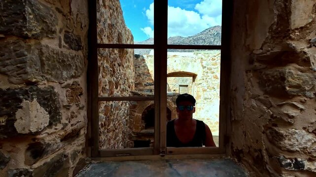 Tourist visiting Spinalonga fortress in Crete, Greece Heraklion region
