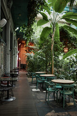 Vertical shot of eco cafe exterior with trees and plants