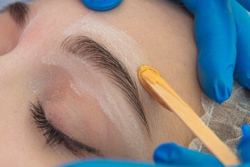 Closeup of An Eye of Caucasain Female During Eyebrow Epilation During Facial Depilation Using Wood...