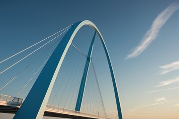 Obraz premium A serene and majestic sky blue arch bridge stands prominently against a crisp, clear blue sky with a few wispy white clouds