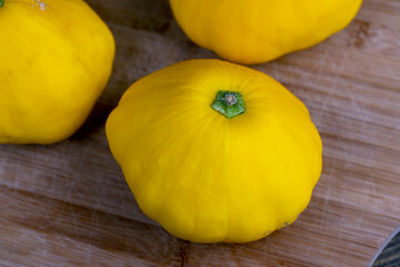 yellow ripe pumpkins on the table in close-up