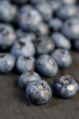 a pile of blueberries scattered on the board