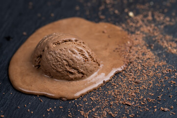 chocolate ice cream with chocolate chips on black slate