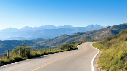 Fototapeta premium Picturesque Winding Mountain Roads - Scenic Hilltop Routes with Panoramic Valley Views and Distant Peaks for Perfect Driving Experiences