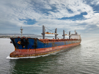 Fototapeta premium Aerial view of dry cargo ship. Bulk carrier cargo vessel. Ship logistic and transportation business industry.