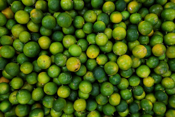 Top view a heap of fresh green limes background.