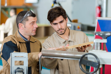 craftsman and apprentice in workshop