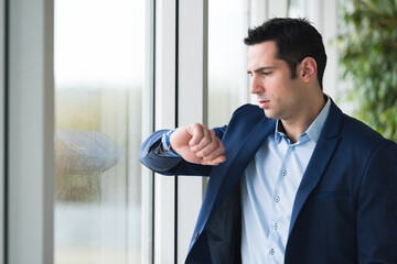 close up of businessman in grey suit looking watch