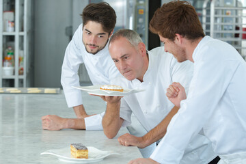 male baker teaching pastry to males students