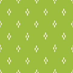Seamless vector pattern with clusters of hand drawn white dots on brat green, textile print