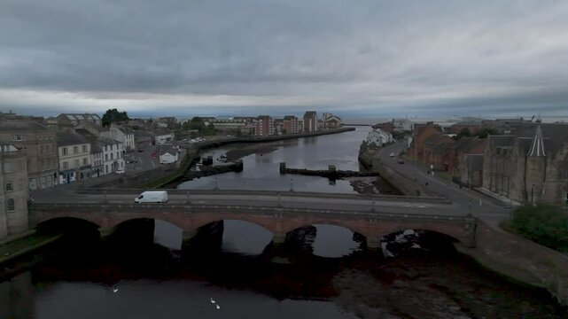 White van crossing bridge in scottish town