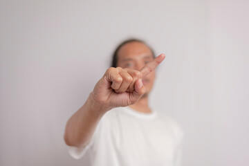 Angry and serious young male saying no, showing stop index finger gesture, frowning annoyed,...
