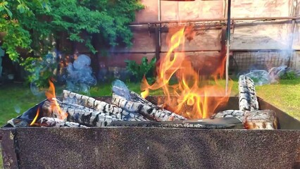 Barbecue fire burning, flames of fire and smoke for the grill