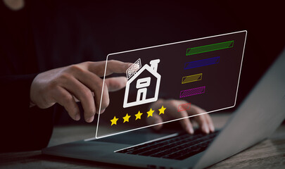person reviews a home’s solar energy on a laptop, analyzing such as energy performance,...
