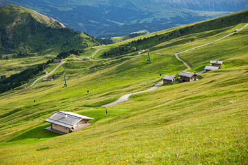 small mountain gut and curved path in a blanket-like grass spread the valley, Seceda, Dolomites, Italy 