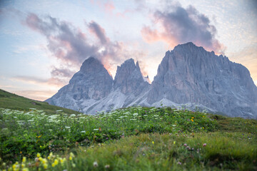 Fototapeta premium The mountain peak of Sassolungo with cloud up on the top at sunset, Passo Sella, Dolomites, Italy