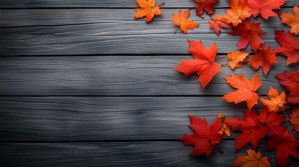 Vibrant autumn leaves in shades of red and orange scattered on rustic wooden surface create warm and inviting atmosphere.