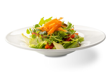 Salad with lettuce, corn salad, cucumber, carrots and tomatoes in white plate isolated