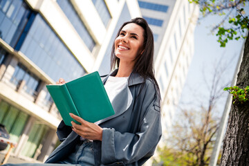 Fototapeta premium Photo of dreamy pretty lady dressed grey jacket writing story enjoying sunshine outdoors town street
