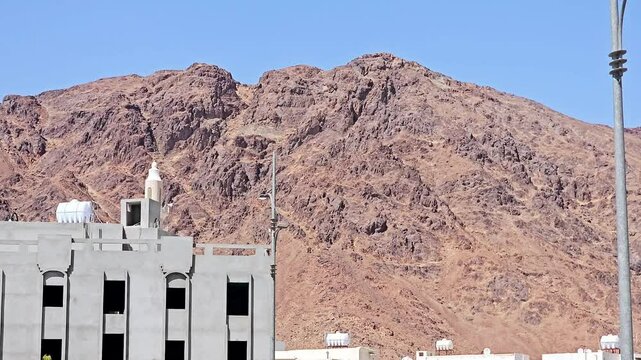 Mount Uhud, a mountain north of Medina, the site of the second battle between the Islamic prophet Muhammad and the polytheists of his tribe of Quraysh, Area also has Archers' hill and martyrs graves