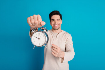 Photo of nice young man point finger alarm wear pajama isolated on blue color background