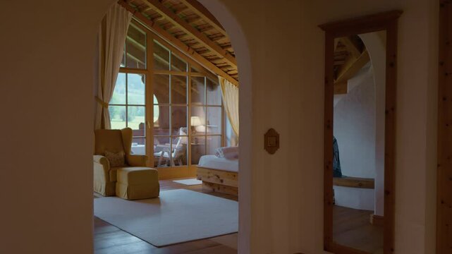 Cozy apartment in a winter eco hotel room in the mountains with wood furniture. Guest houses with balcony in winter forest.