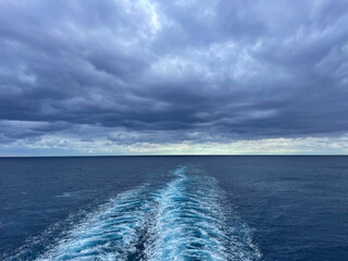 Atlantic ocean with cloudy sky and waves from a cruise ship