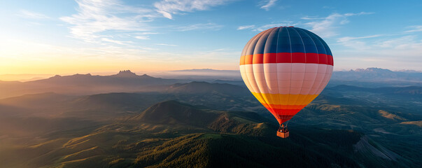 Obraz premium A peaceful colorful hot air balloon drifts over stunning mountain landscapes at sunset, creating serene and picturesque scene