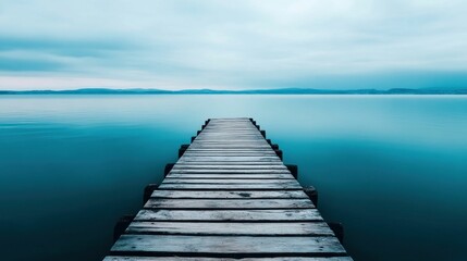 Fototapeta premium Long Wooden Pier Leading into a Calm Blue Sea