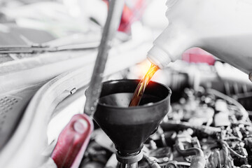 Closeup change of oil in car service garage with sun light