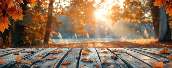 Rustic wooden table surface with orange leaves, blurred autumn forest background and warm sunlight. Free copy space for text.