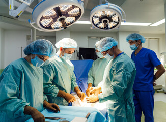 Surgical team operating in a bright hospital. A skilled surgical team collaborates diligently in an...