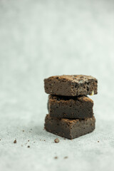 Stacked mini chocolate brownie with chocolate chip, Bite size moist brown chocolate brownie, confectionery and sweets concept.