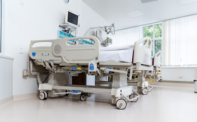 A hospital bed with a monitor on it. The room is clean and well-lit