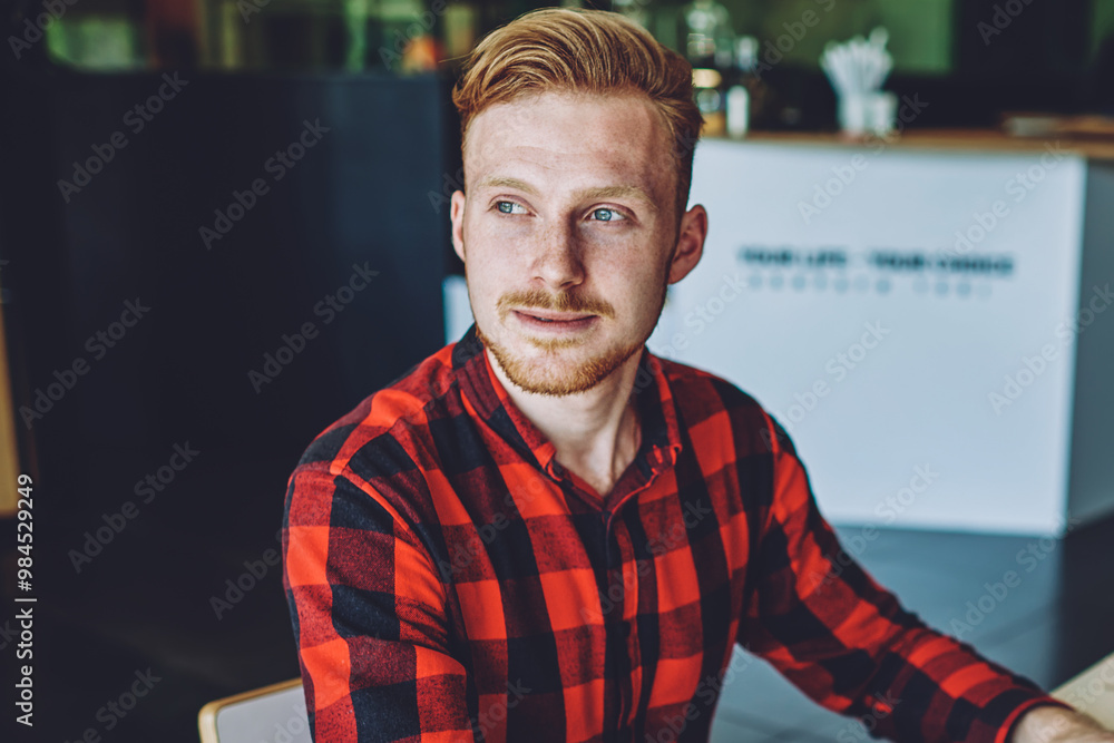 Aufkleber thoughtful male software developer waiting for call from internet provider while sitting at desk wit