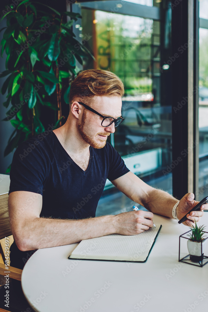 Aufkleber caucasian male blogger writing searching content information for making notes in textbook using 4g c