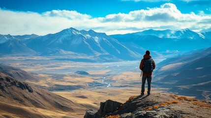 Fototapeta premium A traveler standing at the edge of a high Tibetan plateau, taking in the breathtaking view of the surrounding mountains and valleys