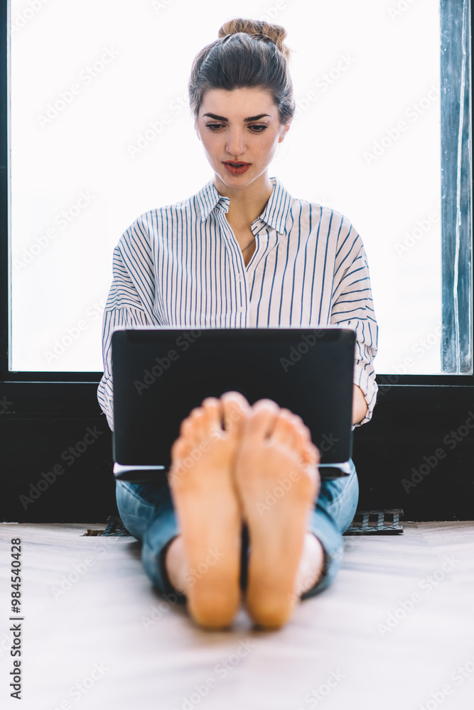 Aufkleber attractive caucasian female programmer working remotely at own laptop device while sitting at floor 
