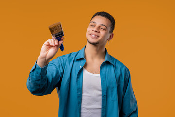 Creative painter artist man with brush on Yellow background. Fantasy, idea © kohanova1991