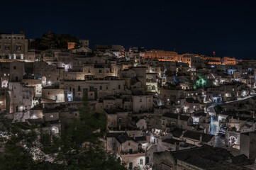 A picturesque city at night illuminated by vibrant lights on the buildings