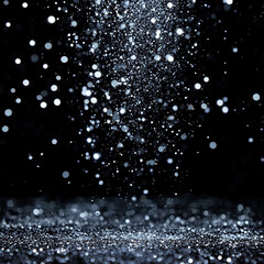 Silver glitter raining down in mid-air