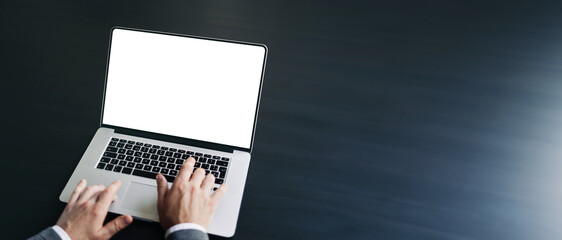 Close up of male hands and laptop with blank screen. Mock-up of computer monitor. Copyspace ready...