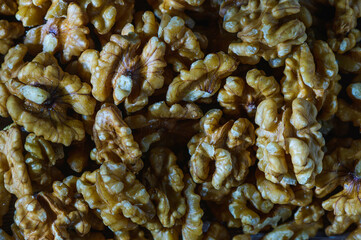 Many tasty walnuts as background, top view closeup of shelled organic walnut halves